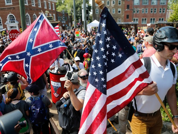 Alt Right demonstrators walk into Lee park surrounded by counter demonstrators in Charlottesville, Va., Saturday, Aug. 12, 2017.  (AP Photo/Steve Helber)