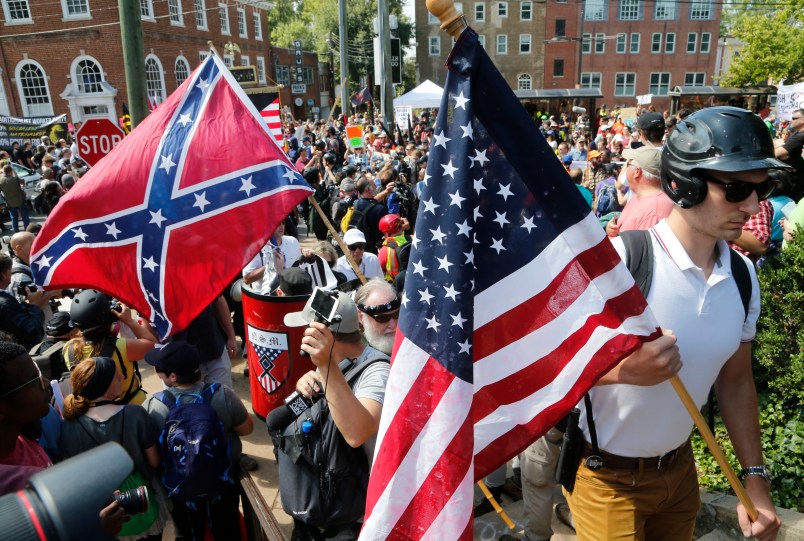 Alt Right demonstrators walk into Lee park surrounded by counter demonstrators in Charlottesville, Va., Saturday, Aug. 12, 2017.  (AP Photo/Steve Helber)