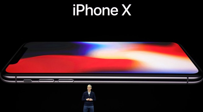 Apple CEO Tim Cook, announces the new iPhone X at the Steve Jobs Theater on the new Apple campus on Tuesday, Sept. 12, 2017, in Cupertino, Calif. (AP Photo/Marcio Jose Sanchez)