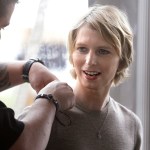 Chelsea Manning, right, is assisted with a microphone, Sunday, Sept. 17, 2017, before a scheduled appearance at a forum, in Nantucket, Mass. The planned forum is part of The Nantucket Project's annual gathering on the island of Nantucket. Manning is a former U.S. Army intelligence analyst who spent seven years in prison for sharing classified documents. (AP Photo/Steven Senne)