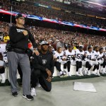 Some members of the Oakland Raiders sits on the bench during the playing of the National Anthem before an NFL football game against the Washington Redskins in Landover, Md., Sunday, Sept. 24, 2017. (AP Photo/Alex Brandon)