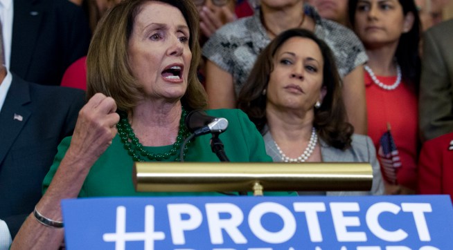 House Minority Leader Nancy Pelosi of Calif. accompanied by members of the House and Senate Democrats, gestures during a news conference on Capitol Hill in Washington, Wednesday, Sept. 6, 2017. House and Senate Democrats gather to call for Congressional Republicans to stand up to President Trump's decision to terminate the Deferred Action for Childhood Arrivals (DACA) initiative by bringing the DREAM Act for a vote on the House and Senate Floor. ( AP Photo/Jose Luis Magana)