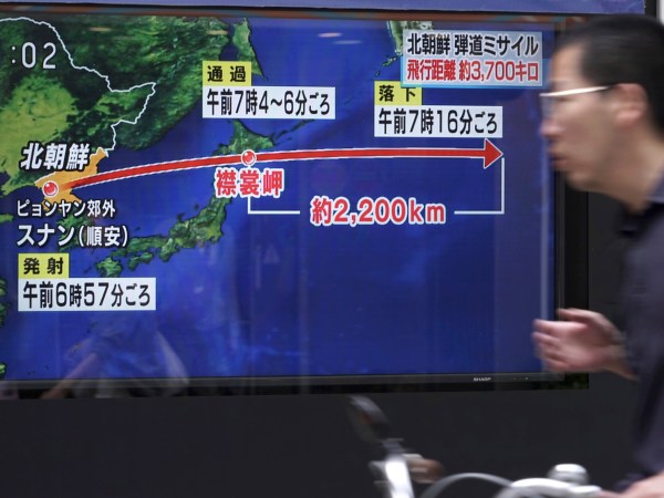 A man rides a bicycle past a public TV screen broadcasting news of North Korea's launch of  missile, in Tokyo, Friday, Sept. 15, 2017. South Korea's military said North Korea fired an unidentified missile Friday from its capital Pyongyang that flew over Japan before landing in the northern Pacific Ocean. (AP Photo/Eugene Hoshiko)