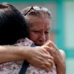 Maria Susana Fernandez Lopez embraces a neighbor outside a school working as a temporary home where she is living after loosing her home during the earthquake in Mexico City, Mexico, Tuesday, Sept. 26, 2017. (AP Photo/Natacha Pisarenko)