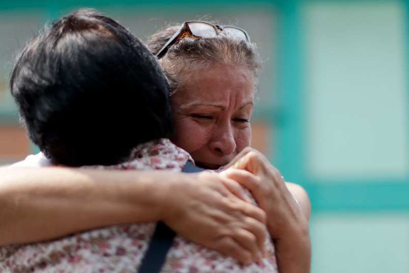 Maria Susana Fernandez Lopez embraces a neighbor outside a school working as a temporary home where she is living after loosing her home during the earthquake in Mexico City, Mexico, Tuesday, Sept. 26, 2017. (AP Photo/Natacha Pisarenko)