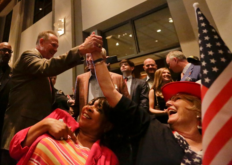 Former Alabama Chief Justice and U.S. Senate candidate Roy Moore, greets supporter Patricia Jones, right, before his election party, Tuesday, Sept. 26, 2017, in Montgomery, Ala.(AP Photo/Brynn Anderson)