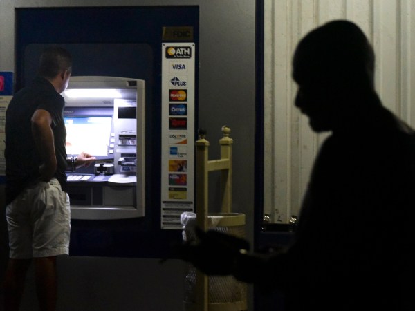 Clients of Popular Bank of Puerto Rico wait in line at the Carolina Shopping Court branch to withdraw cash from their accounts after the passage of Hurricane Maria a week ago, in Carolina, Puerto Rico, Wednesday, September 27, 2017. Because of the communications blackout caused by Maria, cash is the only way to buy gasoline and general basic supplies. (AP Photo/Carlos Giusti)