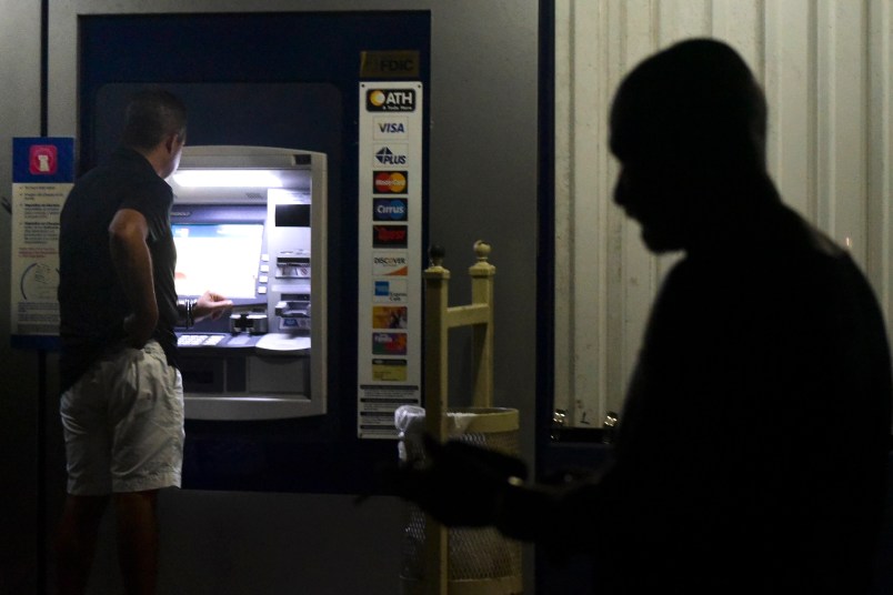 Clients of Popular Bank of Puerto Rico wait in line at the Carolina Shopping Court branch to withdraw cash from their accounts after the passage of Hurricane Maria a week ago, in Carolina, Puerto Rico, Wednesday, September 27, 2017. Because of the communications blackout caused by Maria, cash is the only way to buy gasoline and general basic supplies. (AP Photo/Carlos Giusti)