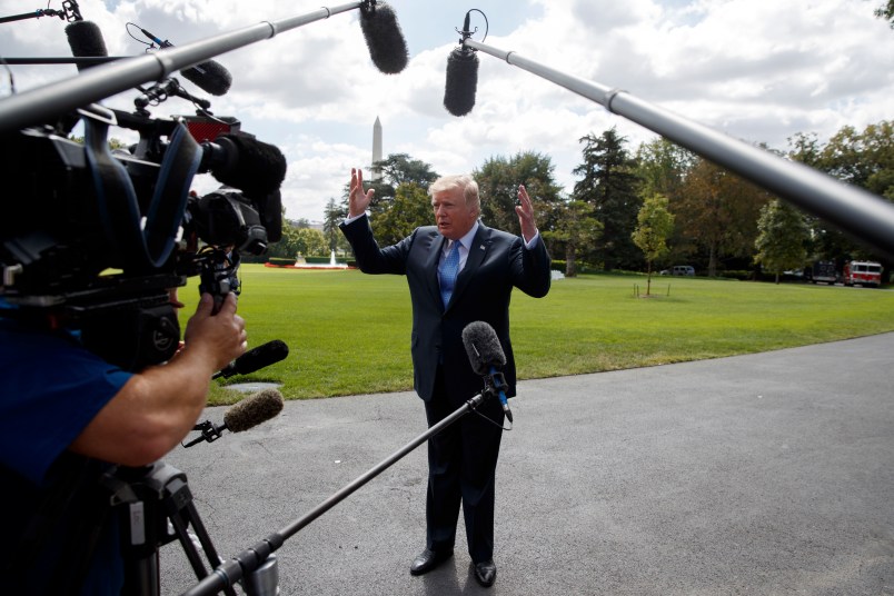 President Donald Trump talks to reporters as he walks to board Marine One on the South Lawn of the White House, Wednesday, Sept. 27, 2017, in Washington. (AP Photo/Evan Vucci)