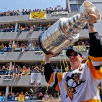 Pittsburgh Penguins' Sidney Crosby hoists the Stanley Cup while riding in the Stanley Cup victory parade in Pittsburgh, Wednesday, June 14, 2017. (AP Photo/Gene J. Puskar)