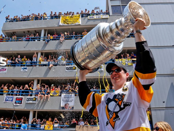 Pittsburgh Penguins' Sidney Crosby hoists the Stanley Cup while riding in the Stanley Cup victory parade in Pittsburgh, Wednesday, June 14, 2017. (AP Photo/Gene J. Puskar)