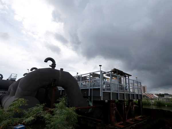 FILE -In this Thursday, Aug. 10, 2017 file photo, rain clouds gather over the 17th Street Canal pumping station in New Orleans.  Flood-weary New Orleans braced Thursday for the weekend arrival of Tropical Storm Nate, forecast to hit the area Sunday morning as a weak hurricane that could further test a city drainage system in which weaknesses were exposed during summer deluges.(AP Photo/Gerald Herbert, File)