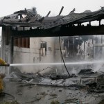 A Santa Rosa firefighter hoses down a hotspot in the Coffey Park area of Santa Rosa, Calif., on Tuesday, Oct. 10, 2017, An onslaught of wildfires across a wide swath of Northern California broke out almost simultaneously then grew exponentially, swallowing up properties from wineries to trailer parks and tearing through both tiny rural towns and urban subdivisions. (AP Photo/Ben Margot)