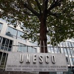 FILE - In this Monday Oct. 17, 2016 file picture, the United Nations Educational Scientific and Cultural Organization logo is pictured on the entrance at UNESCO's headquarters in Paris. U.S. officials have told The Associated Press that the United States is pulling out of UNESCO, after repeated criticism of resolutions by the U.N. cultural agency that Washington sees as anti-Israel.  (AP Photo/Francois Mori, File)