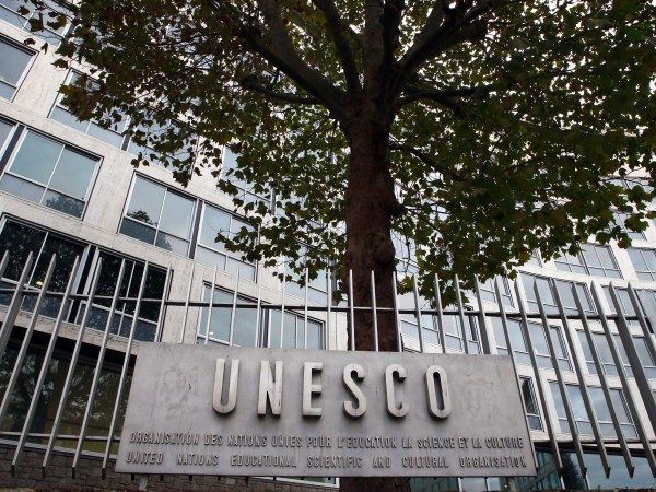 FILE - In this Monday Oct. 17, 2016 file picture, the United Nations Educational Scientific and Cultural Organization logo is pictured on the entrance at UNESCO's headquarters in Paris. U.S. officials have told The Associated Press that the United States is pulling out of UNESCO, after repeated criticism of resolutions by the U.N. cultural agency that Washington sees as anti-Israel.  (AP Photo/Francois Mori, File)