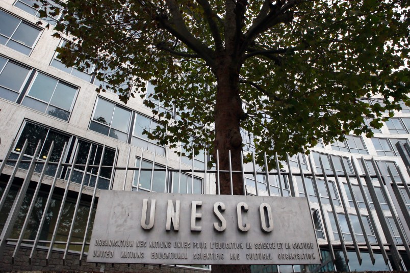 FILE - In this Monday Oct. 17, 2016 file picture, the United Nations Educational Scientific and Cultural Organization logo is pictured on the entrance at UNESCO's headquarters in Paris. U.S. officials have told The Associated Press that the United States is pulling out of UNESCO, after repeated criticism of resolutions by the U.N. cultural agency that Washington sees as anti-Israel.  (AP Photo/Francois Mori, File)