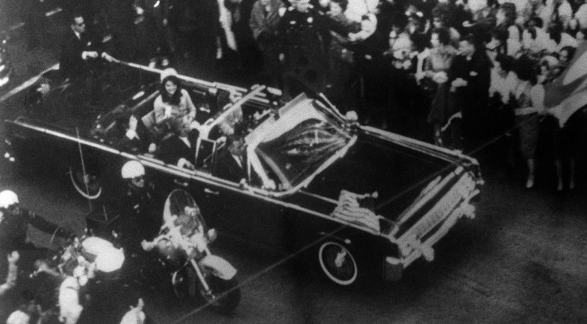 This overhead view of President Kennedy's car in Dallas motorcade on Nov. 22, 1963, was Warren Commission Exhibit No. 698. Special agent Clinton J. Hill is shown riding atop the rear of the limousine. The Warren Commission said agent Hil had to leave the left front running board of the President's follow-up car four times because of dense crowds to ride on the rear of the presidential limousine. (AP Photo)