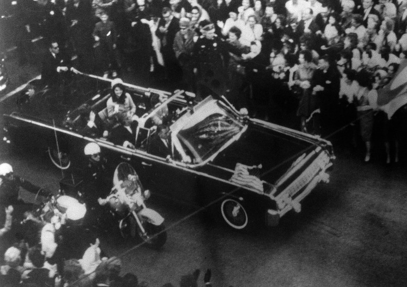 This overhead view of President Kennedy's car in Dallas motorcade on Nov. 22, 1963, was Warren Commission Exhibit No. 698. Special agent Clinton J. Hill is shown riding atop the rear of the limousine. The Warren Commission said agent Hil had to leave the left front running board of the President's follow-up car four times because of dense crowds to ride on the rear of the presidential limousine. (AP Photo)