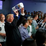President Donald Trump tosses paper towels into a crowd as he hands out supplies at Calvary Chapel, Tuesday, Oct. 3, 2017, in Guaynabo, Puerto Rico. (AP Photo/Evan Vucci)