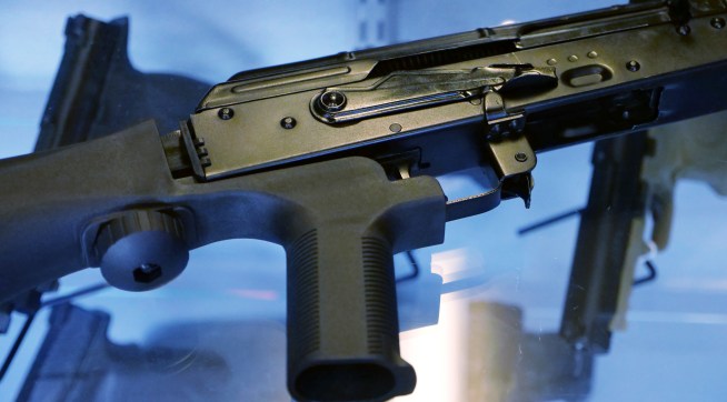 A little-known device called a "bump stock" is attached to a semi-automatic rifle at the Gun Vault store and shooting range Wednesday, Oct. 4, 2017, in South Jordan, Utah. (AP Photo/Rick Bowmer)