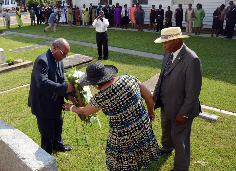 In this Sunday, July 1, 2012, photo, from left, Freddie Meyer, great-great grandson of Robert Smalls, places a wreath in front of Smalls' grave with help from fellow descendant Carolyn Meyer-Little and Edgar Williams, one of the Robert Smalls Association reunion organizers, during the reunion near Tabernacle Baptist Church in Beaufort, S.C. Robert Smalls was an African American slave during and after the Civil War, who freed himself, his crew and their families by commandeering a Confederate transport ship, the CSS Planter, and sailing it to freedom. (AP Photo/The Beaufort Gazette, Sarah Welliver)