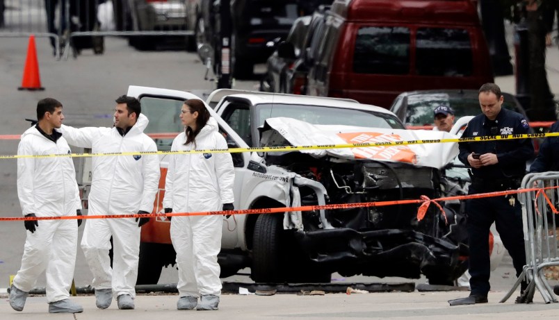 Law enforcement personnel examine the scene of a damaged Home Depot truck near the World Trade Center Memorial, Wednesday,  Nov. 1, 2017 in New York. (AP Photo/Mark Lennihan)