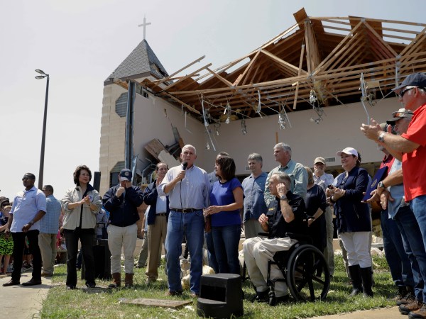 MOVE AT 9:00 AM EASTERN TUESDAY NOV. 7 - FILE - in this Aug. 31, 2017 file photo, Vice President Mike Pence,with his wife Karen, speak to residents affected by Hurricane Harvey during a visit to the First Baptist Church, in Rockport, Texas. The church, which was hit by Harvey, has not filed a lawsuit against the Federal Emergency Management Agency, challenging the agency's policy of denying disaster aid to repair or rebuild places of worship as others have. When disaster strikes, religious institutions like churches and synagogues often form a community’s front line of response while working alongside the Federal Emergency Management Agency. Places of worship are routinely denied FEMA aid when it comes time to repair and rebuild their own damaged sanctuaries. (AP Photo/Eric Gay File)
