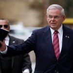 U.S. Sen. Bob Menendez waves at reporters before entering the Martin Luther King Jr. Federal Courthouse for his federal corruption trial, Thursday, Nov. 16, 2017, in Newark, N.J. Jury deliberations continued on Thursday morning. (AP Photo/Julio Cortez)