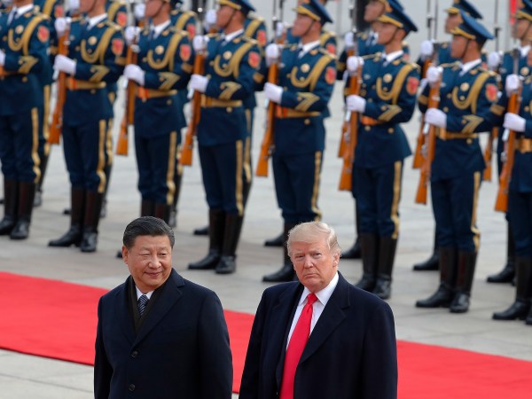 U.S. President Donald Trump, right, walks with Chinese President Xi Jinping during the welcome ceremony at the Great Hall of the people in Beijing, Thursday, Nov. 9, 2017. (AP Photo/Andy Wong)