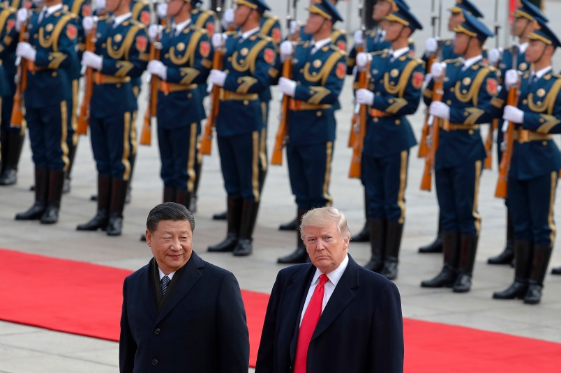 U.S. President Donald Trump, right, walks with Chinese President Xi Jinping during the welcome ceremony at the Great Hall of the people in Beijing, Thursday, Nov. 9, 2017. (AP Photo/Andy Wong)