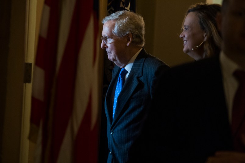 UNITED STATES - NOVEMBER 16: Senate Majority Leader Mitch McConnell, R-Ky., talks with an aide in the Capitol after the House passed the GOP's tax reform bill on November 16, 2017. (Photo By Tom Williams/CQ Roll Call)