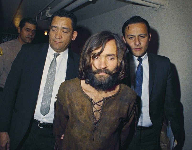 FILE - In this 1969 file photo, Charles Manson is escorted to his arraignment on conspiracy-murder charges in connection with the Sharon Tate murder case. (AP Photo/File)
