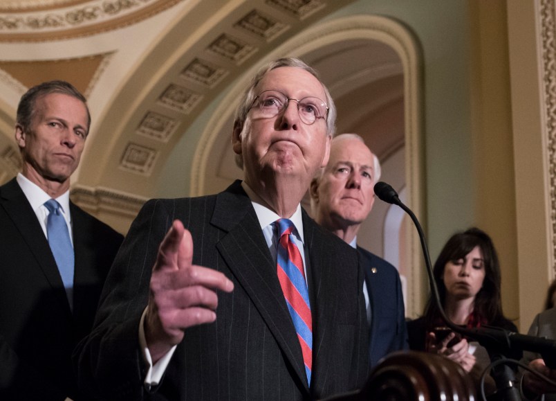 With the deadline looming to pass a spending bill to fund the government by week's end, Senate Majority Leader Mitch McConnell, R-Ky., joined by, from left, Sen. John Thune, R-S.D., and Majority Whip John Cornyn, R-Texas, meets reporters following a closed-door strategy session, on Capitol Hill in Washington, Tuesday, Dec. 5, 2017.  (AP Photo/J. Scott Applewhite)