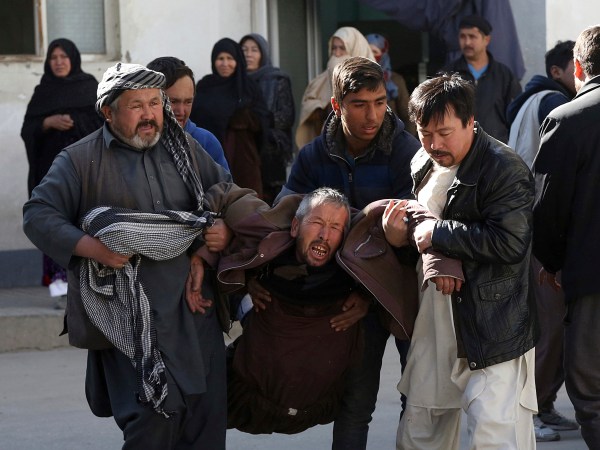 An Afghan man, center, cry after after a suicide attack in Kabul, Afghanistan, Thursday, Dec. 28, 2017. Authorities say two simultaneous attacks, including a suicide bombing attack, in Afghanistan’s capital have left at least 35 dead and 20 wounded. (AP Photo/Rahmat Gul)