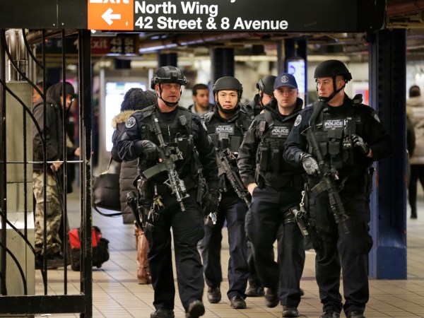 Heavily armed police officers patrol near the site of a terror attack in the subways under Port Authority Bus Terminal in New York, Tuesday, Dec. 12, 2017. A would-be suicide bomber's rush-hour blast in the heart of the New York City subway system failed to cause the bloodshed he intended, authorities said, but it gave new fuel to President Donald Trump's push to limit immigration. (AP Photo/Seth Wenig)