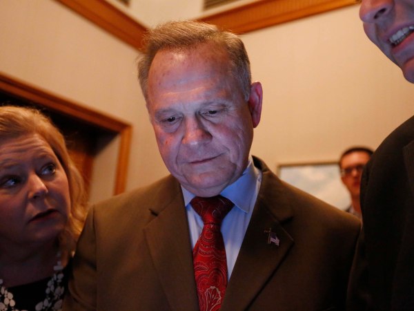 U.S. Senate candidate Roy Moore, center, looks at election returns with staff during an election-night watch party at the RSA activity center, Tuesday, Dec. 12, 2017, in Montgomery, Ala. (AP Photo/Brynn Anderson)