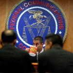 Federal Communications Commission (FCC) Chairman Ajit Pai takes a drink from a mug during introductions during an FCC meeting where they will vote on net neutrality, Thursday, Dec. 14, 2017, in Washington. (AP Photo/Jacquelyn Martin)