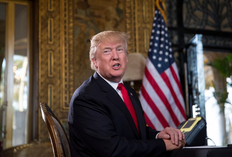 President Donald Trump turns to talk to the gathered media during a Christmas Eve video teleconference with members of the mIlitary at his Mar-a-Lago estate in Palm Beach, Fla., Sunday, Dec. 24, 2017. (AP Photo/Carolyn Kaster)