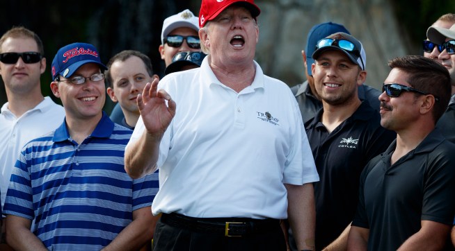 President Donald Trump speaks as he meets with members of the Coast Guard who he invited to play golf at Trump International Golf Club, Friday, Dec. 29, 2017, in West Palm Beach, Fla. (AP Photo/Evan Vucci)