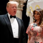 First lady Melania Trump looks on as President Donald Trump speaks with reporters after arriving for a New Year's Eve gala at his Mar-a-Lago resort, Sunday, Dec. 31, 2017, in Palm Beach, Fla. (AP Photo/Evan Vucci)