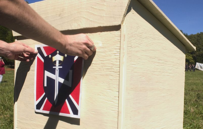 SCOTTSBORO, AL - SEPTEMBER 18: An Aryan Nations member puts the final touches on a the podium that will be used for speakers at the Aryan Nations sponsored White Heritage Days Festival September 18, 2004, which was held on private land near Scottsboro, Alabama. The event was originally scheduled as a pro-white family-friendly gathering, yet also served as an East Coast memorial to Pastor Richard G. Butler, the Aryan Nations founder who died about two weeks earlier at his home in Coure D'Alene, Idaho. The family-friendly event was attended by over 100 people, including members of Aryan Nations, White Revolution, the Ku Klux Klan and several independent, but racially conscious people. (Photo by David S. Holloway/Getty Images)