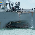 170821-N-OU129-022CHANGI NAVAL BASE, REPUBLIC OF SINGAPORE – Damage to the portside is visible as the Guided-missile destroyer USS John S. McCain (DDG 56) steers towards Changi Naval Base, Republic of Singapore, following a collision with the merchant vessel Alnic MC while underway east of the Straits of Malacca and Singapore on Aug. 21. Significant damage to the hull resulted in flooding to nearby compartments, including crew berthing, machinery, and communications rooms. Damage control efforts by the crew halted further flooding. The incident will be investigated. (U.S. Navy photo by Mass Communication Specialist 2nd Class Joshua Fulton/Released)