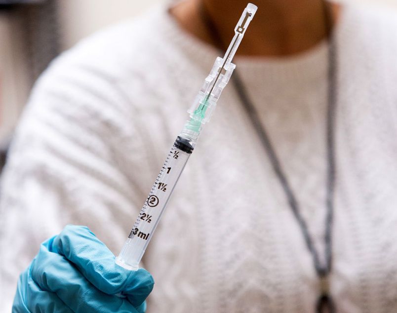 BETHESDA, MD - NOVEMBER 21: Nurse Floreliz Mendoza holds the syringe she has used to inject Andie Vaught, 25, with an experimental Zika vaccine as part of a clinical trial at the National Institute of Health Clinical Center in Bethesda, Maryland, November 21, 2016. This vaccine, one of about six or seven in different phases of clinical trial, is currently undergoing safety testing at three locations in the country. Instead of using dead or weakened virus to get the immune system to recognize the infection and fight it off, it uses a piece of DNA engineered to contain genes that code for proteins of the Zika virus. (Photo by Allison Shelley/For The Washington Post)