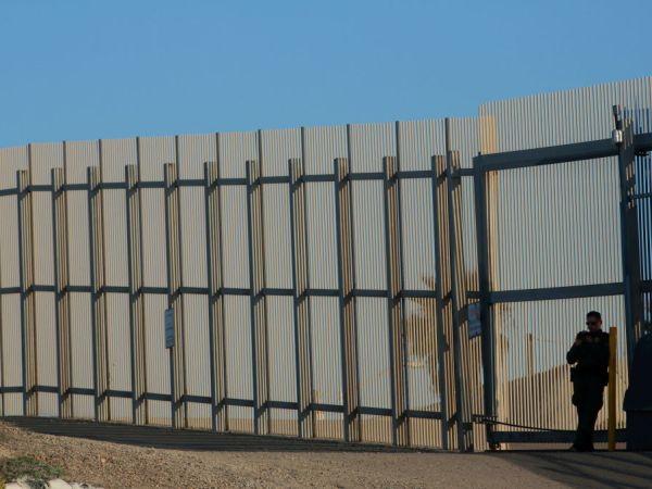SAN YSIDRO, CA-FEB 7: A border patrol officer stands guard along the U.S.-Mexico border on Wednesday, February 7, 2018 in San Ysidro, California.  The rally coincides on the eve of Congress's spending bill deadline and is urging lawmakers to pass a clean Dream Act without provisions for a border wall.(Photo by Sandy Huffaker/Getty Images)