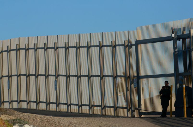 SAN YSIDRO, CA-FEB 7: A border patrol officer stands guard along the U.S.-Mexico border on Wednesday, February 7, 2018 in San Ysidro, California.  The rally coincides on the eve of Congress's spending bill deadline and is urging lawmakers to pass a clean Dream Act without provisions for a border wall.(Photo by Sandy Huffaker/Getty Images)