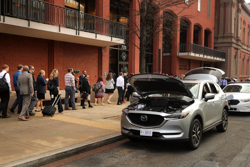 A suspicious vehicle stands with its doors, hood and tailgate open after being inspected in front of the New Executive Office Building, tying up rush hour traffic for blocks near the White House, February 21, 2018 in Washington, DC. The vehicle was later declared safe.