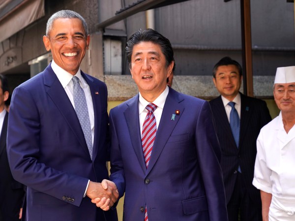 Former U.S. President Barack Obama and Japanese Prime Minister Shinzo Abe pose for photographers in front of Japanese Sushi restaurant in Tokyo's Ginza shopping district, Sunday, March 25, 2018. (AP Photo/Shizuo Kambayashi, Pool)