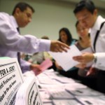 PASADENA, CA - MAY 14:  Job seekers look over job opening fliers at the WorkSource exhibit, a collaborative effort by governmental agencies to offer jobs and job training resources at the Greater Los Angeles Career Expo at the Pasadena Convention Center on May 14, 2009 in Pasadena, California. Nineteen exhibitors offer job and educational opportunities as well as advice from the Board of Equalization at the event that is open to the general public.  (Photo by David McNew/Getty Images)