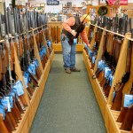 Gregory Rec/Staff Photographer...Don Parizo of Vermont looks over hunting rifles at Kittery Trading Post in Kittery on Wednesday, November 19, 2008.