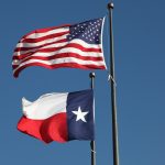 American flag and Texas flag flying at the  LBJ Library in Austin.